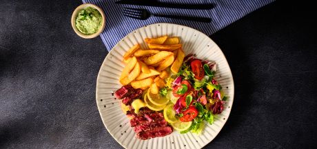 Butter steak with pickled lemon, green salad and fries with mayonnaise and zhoug