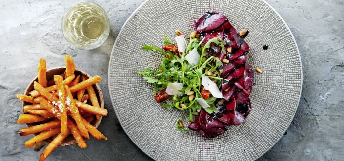 AVIKO Sweet potato fries with pickled beetroot salad with arugula, sun-dried tomatoes and goat cheese