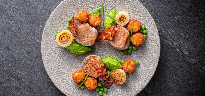 AVIKO Mini Rösti with pork tenderloin medallions, crispy bacon and fresh pea pasta